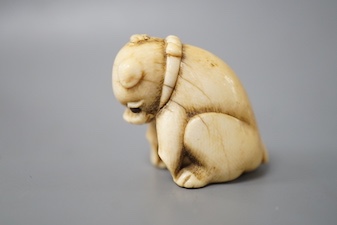 A 19th century Japanese carved ivory ‘dog’ netsuke 3cm tall